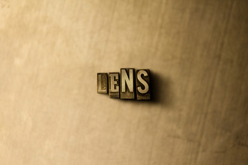 LENS - close-up of grungy vintage typeset word on metal backdrop. Royalty free stock illustration.  Can be used for online banner ads and direct mail.