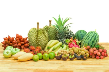 Poster Fresh mixed fruits on wood table isolated on white background. © yotrakbutda