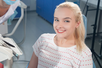 blonde girl smiling in a dentist's office