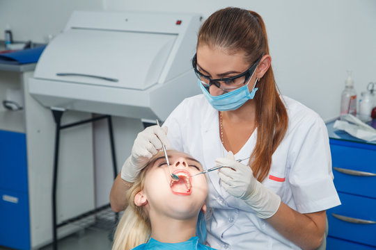 The dentist examines the patient using mirror
