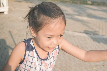 Beautiful Asian girl playing outside.