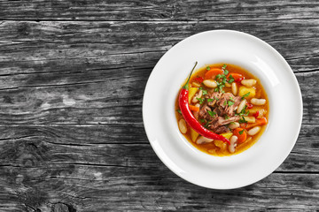 hot oxtail meat soup with root vegetables