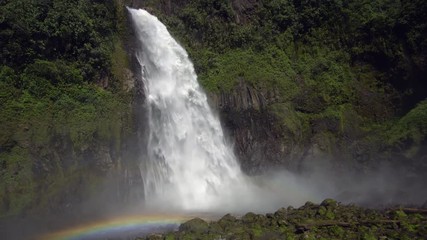 Cascada Magica (Magic Waterfall) with double rainbow and mist blowing towards camera. In the Rio Malo Valley, the Ecuadorian Amazon. Runs over a basalt cliff in an area of extremely high humidity. - Powered by Adobe