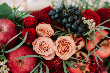 Autumnal wedding bouquet of roses, apples, grape and pomergranate