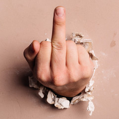 Middle finger through the wall hole