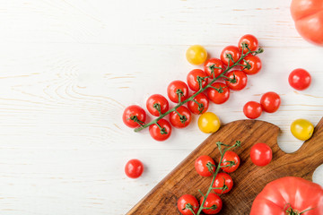 Fototapeta na wymiar Tomatoes and cutting board