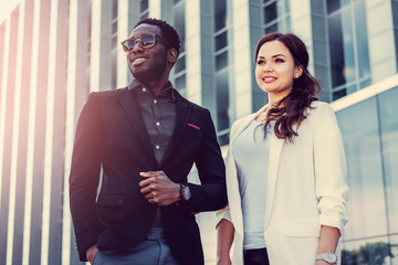 Black male and brunette Caucasian woman in a downtown.