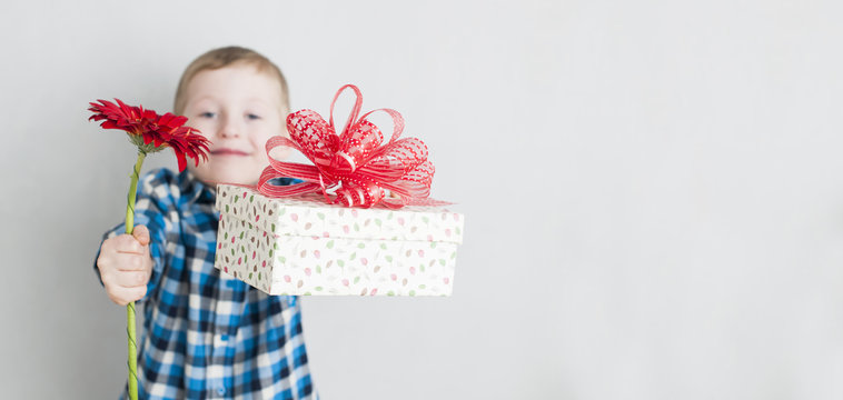 little boy with red flower and gift box
