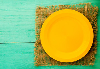 plate on a wooden background. yellow plate .plate top view. copy space