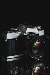 classic film camera on black background - 137929569