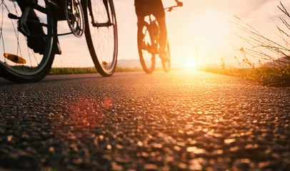 Stickers muraux Vélo Bike wheels close up image on asphalt sunset road