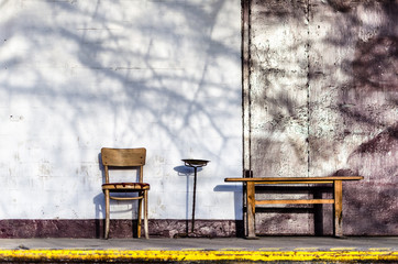 old chair, bench next to white wall - 137930313