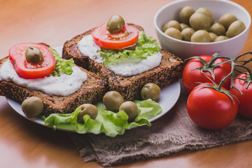 Vegetarian Sandwiches of homemade bread with cheese sauce or cream, lettuce