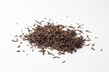 Dried black Chinese tea leaves on white background