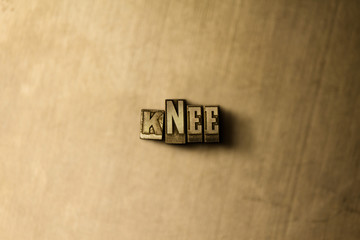 KNEE - close-up of grungy vintage typeset word on metal backdrop. Royalty free stock illustration.  Can be used for online banner ads and direct mail.