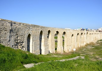 Fototapeta na wymiar Architecture from old aqueduct and blue sky