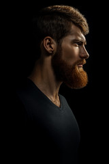 Portrait of young handsome bearded man looking forward
