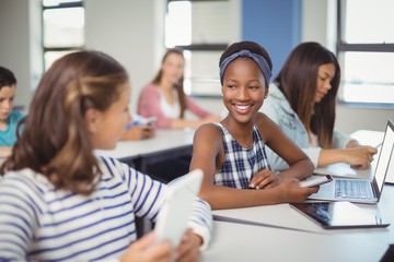 Students interacting with each other in classroom