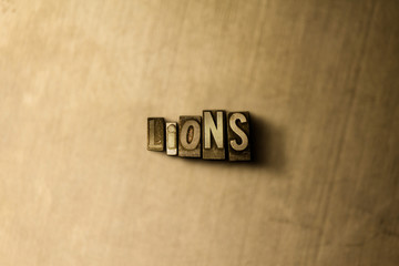 LIONS - close-up of grungy vintage typeset word on metal backdrop. Royalty free stock illustration.  Can be used for online banner ads and direct mail.
