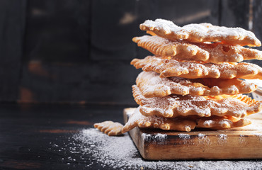  Frappe or chiacchiere  - typical Italian carnival fritters dusted with powdered sugar on   old...