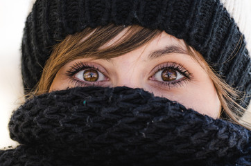 closeup of young woman wearing scarf and winter cap - 137936540