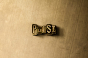 PULSE - close-up of grungy vintage typeset word on metal backdrop. Royalty free stock illustration.  Can be used for online banner ads and direct mail.