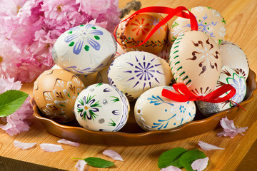 Obraz na płótnie Canvas Colored Easter Eggs With Blossom On The Table