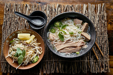 vietnamese pho with beef brisket in flat lay composition