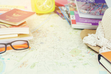 Traveling concept : Passport , city maps , eyeglasses , woven hat , books