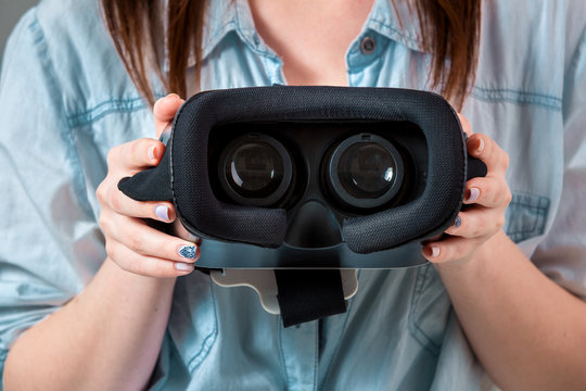 Girl offers to wear glasses virtual reality, VR goggles, VR-headset glasses