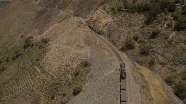 Peru Mountains Aerial v11 Flying over train panning in Huarochiri Province.