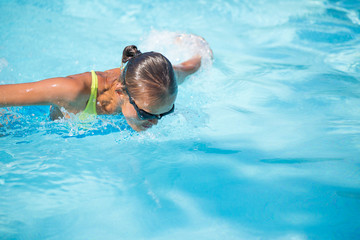 Pretty female swimmer in a pool, getting her daily dose of exercise without stressing her joints