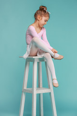 The little balerina dancer on blue background © master1305