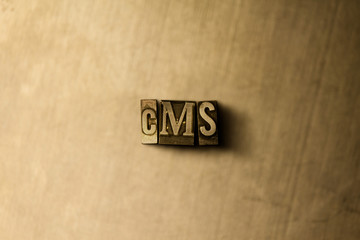 CMS - close-up of grungy vintage typeset word on metal backdrop. Royalty free stock illustration.  Can be used for online banner ads and direct mail.