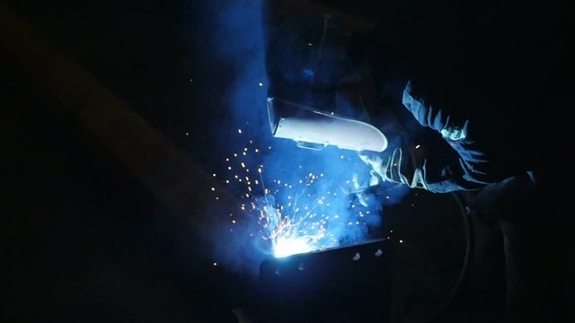 Welder at work in metal industry shot in slow motion 100fps
