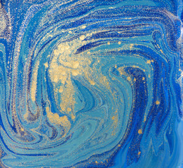 Blue and gold liquid texture. Hand drawn marbling background. Ink marble abstract pattern