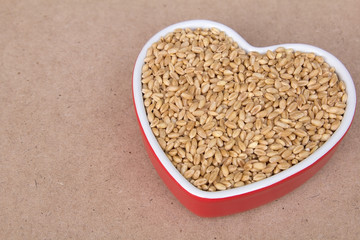 Wheat grain in heart shaped porcelain dish