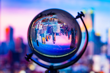Crystal globe reflection cityscape building inside with blur background