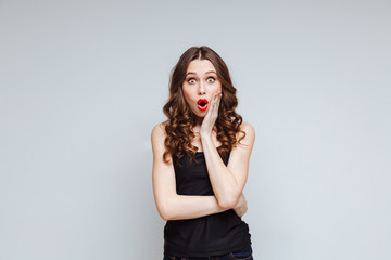 Fototapeta premium Shocked woman with arm on cheek