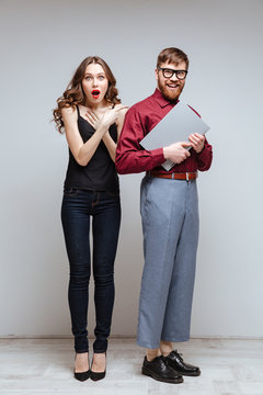 Vertical image of Surprised woman with Male nerd