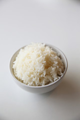 Cooked rice in bowl isolated in white background