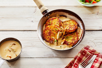 Crisp Potato Pancakes in Pan with Cream Sauce