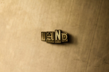 LAND - close-up of grungy vintage typeset word on metal backdrop. Royalty free stock illustration.  Can be used for online banner ads and direct mail.