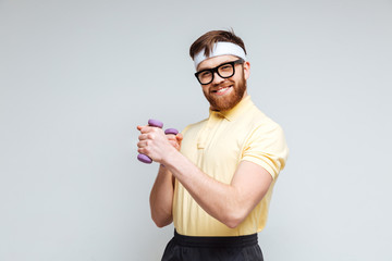Funny male nerd with dumbbells