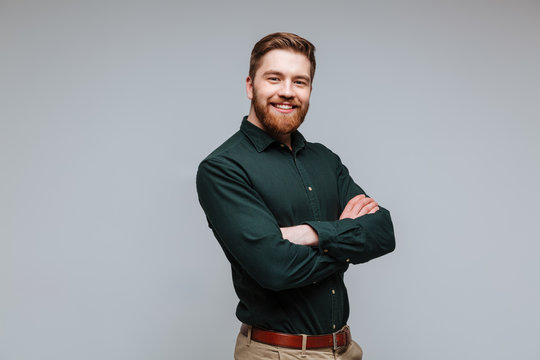 Smiling Bearded man in shirt with crossed arms