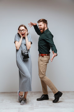 Vertical image of man screming at the female nerd