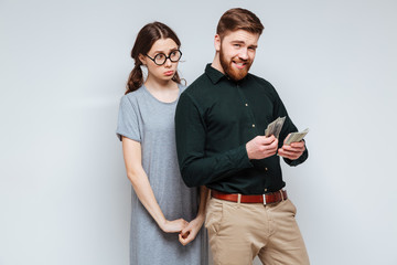 Female nerd with bearded man which recounts money