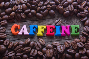 word caffeine and coffee beans - obrazy, fototapety, plakaty