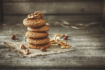 Crispy cookies with cocoa and nuts, dark wood background, selective focus - obrazy, fototapety, plakaty