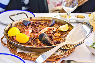 Tasty Seafood Paella in black pan -traditional spanish rice dish